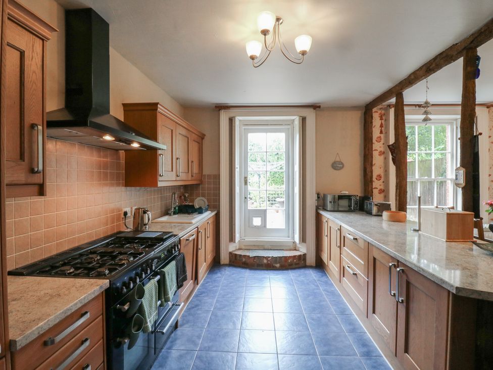 A kitchen with cabinets and appliances at Chilton Manor House in Sittingbourne