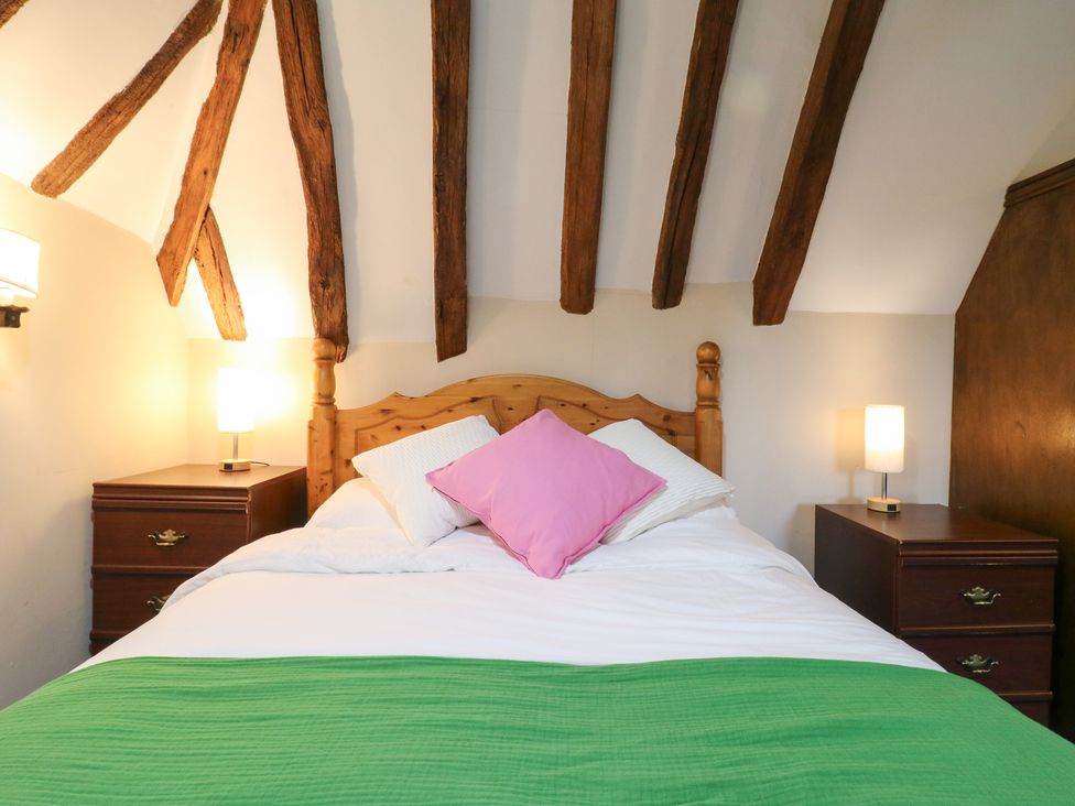A bedroom with a bed and bedside tables at Chilton Manor House Sittingbourne