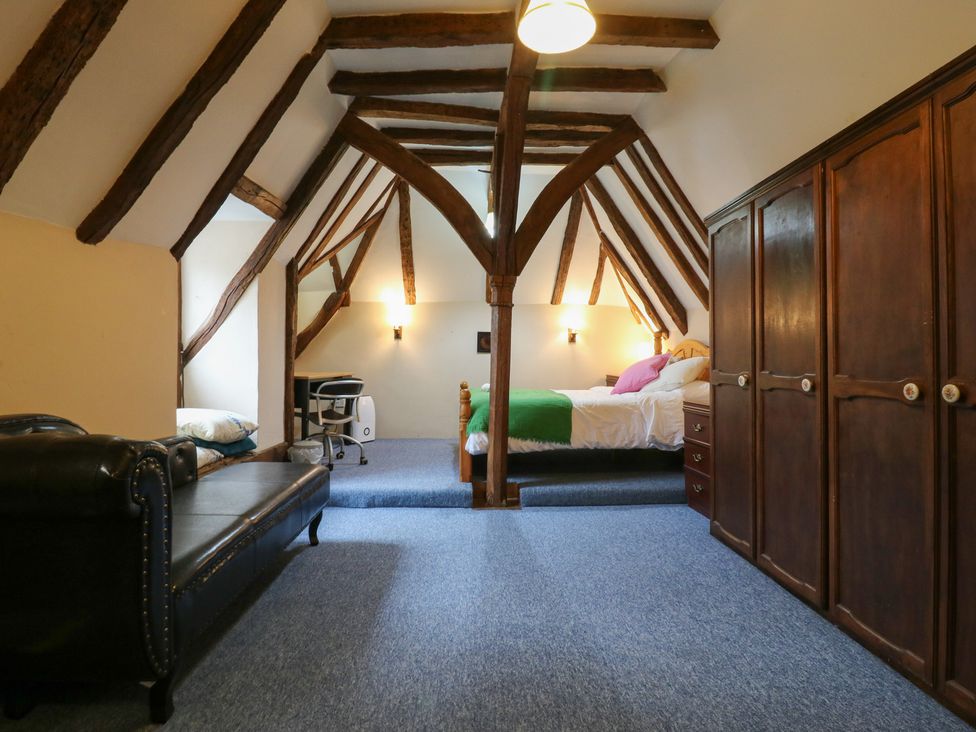 A bedroom with a bed, desk, and wardrobe at Chilton Manor House in Sittingbourne