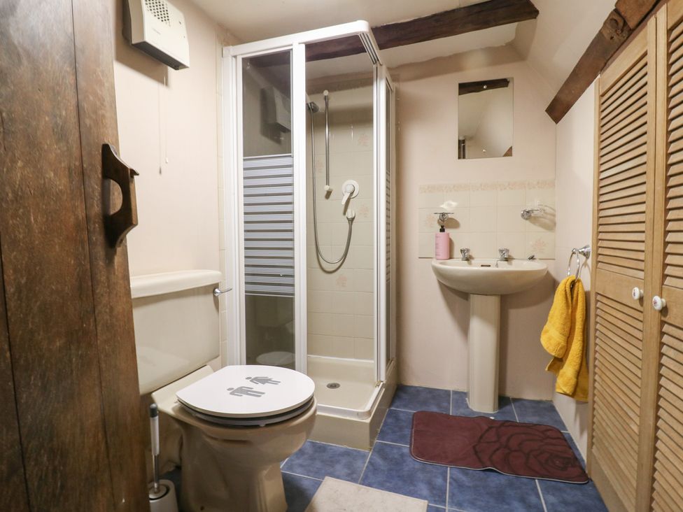 A bathroom with a shower, toilet, and sink at Chilton Manor House in Sittingbourne