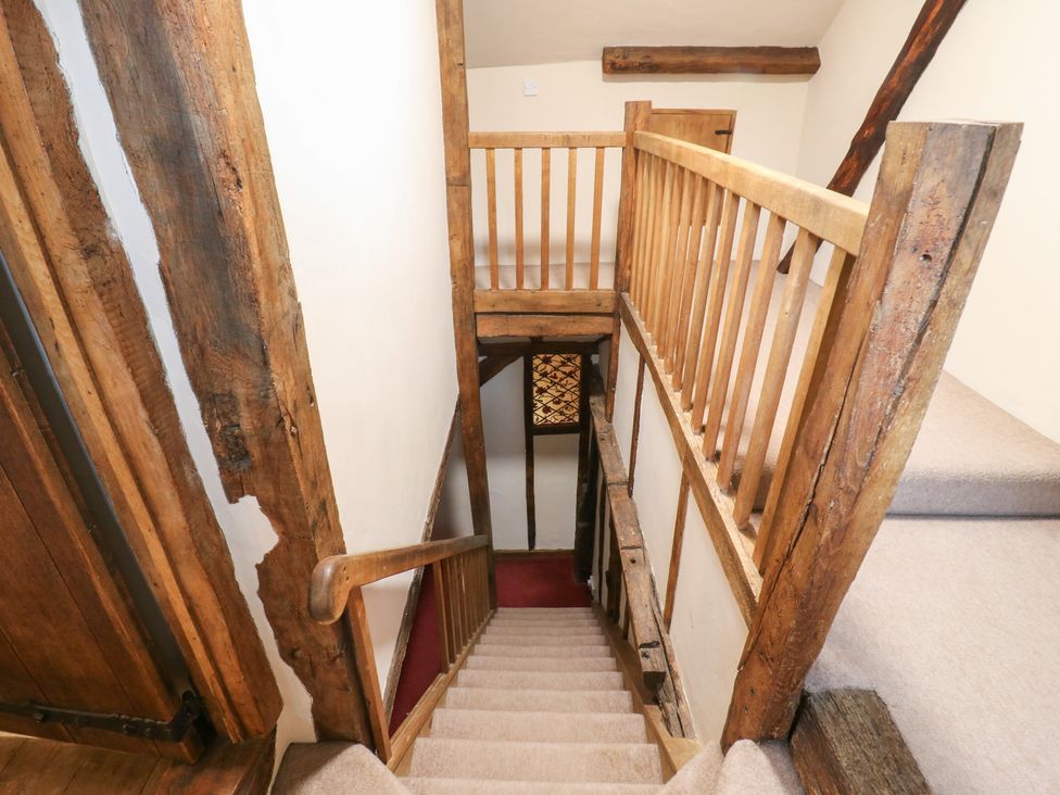 A staircase with wooden railing at Chilton Manor House in Sittingbourne