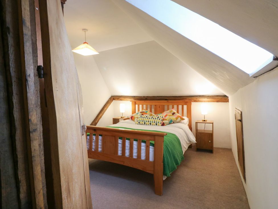A bedroom with a bed and nightstand at Chilton Manor House in Sittingbourne