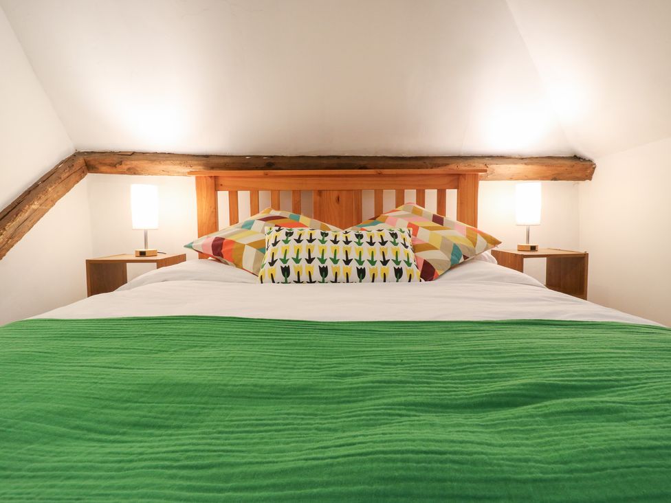 A bedroom with a bed and lamps at Chilton Manor House in Sittingbourne