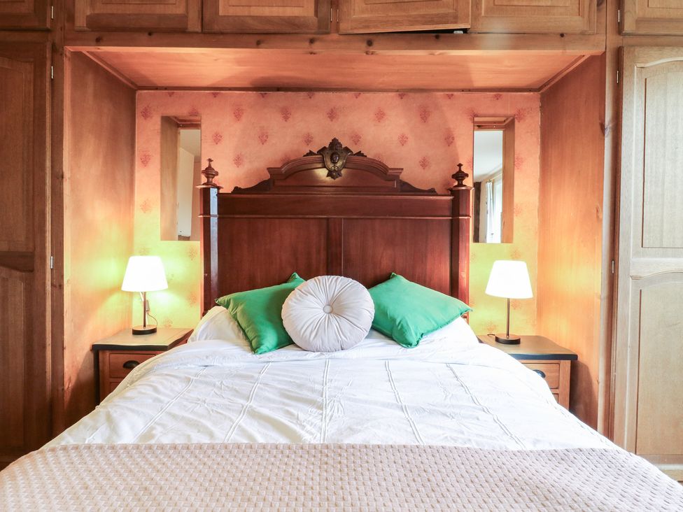 A bedroom with a bed and lamps at Chilton Manor House in Sittingbourne
