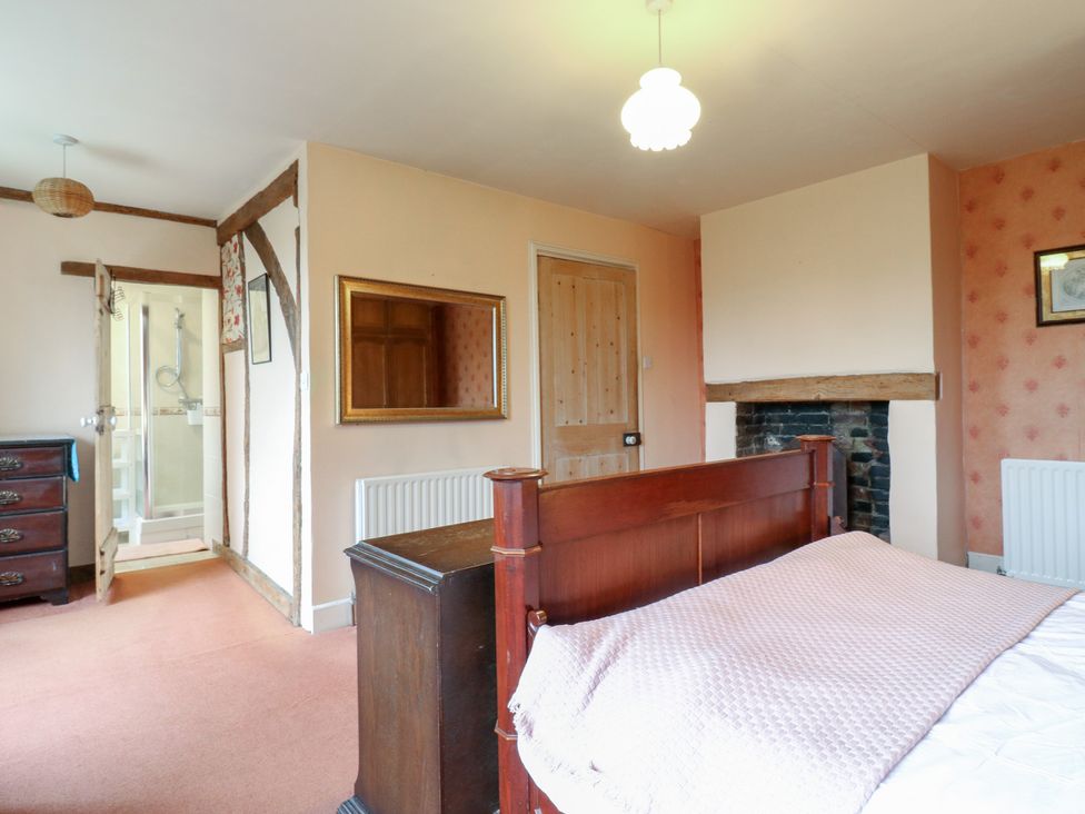 A bedroom with a bed and drawers at Chilton Manor House in Sittingbourne