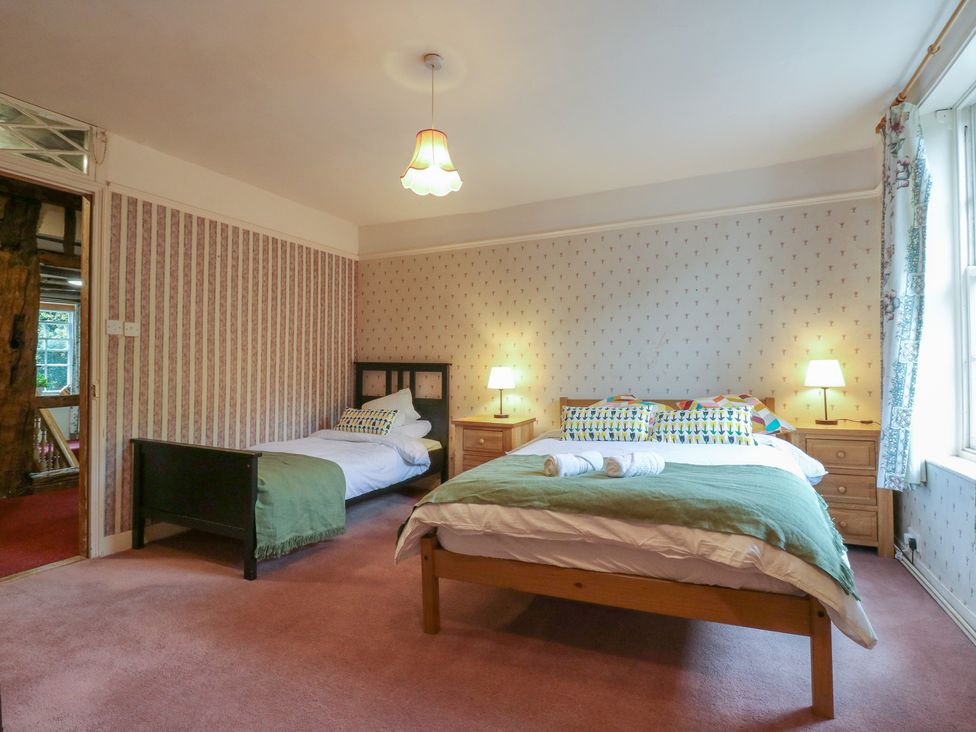 A bedroom with two beds and nightstands at Chilton Manor House in Sittingbourne