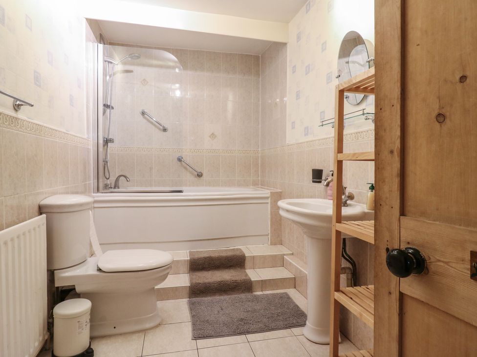 A bathroom with a bath, toilet, and sink at Chilton Manor House Sittingbourne