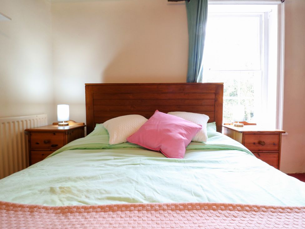 A bedroom with a bed and bedside tables with lamps at Chilton Manor House in Sittingbourne