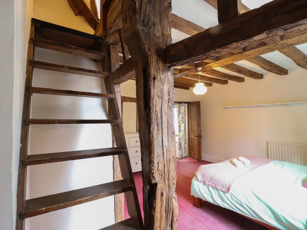 A bedroom with a bed and dresser at Chilton Manor House Sittingbourne