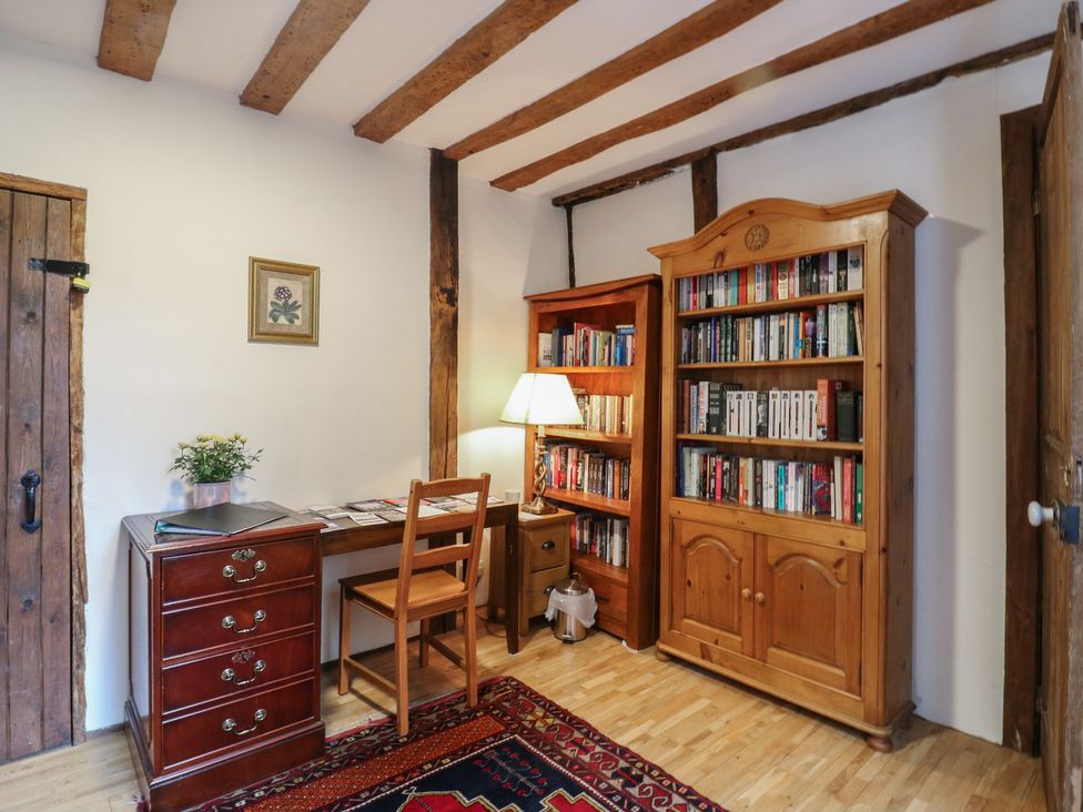 A study with a desk and bookshelf at Chilton Manor House Sittingbourne