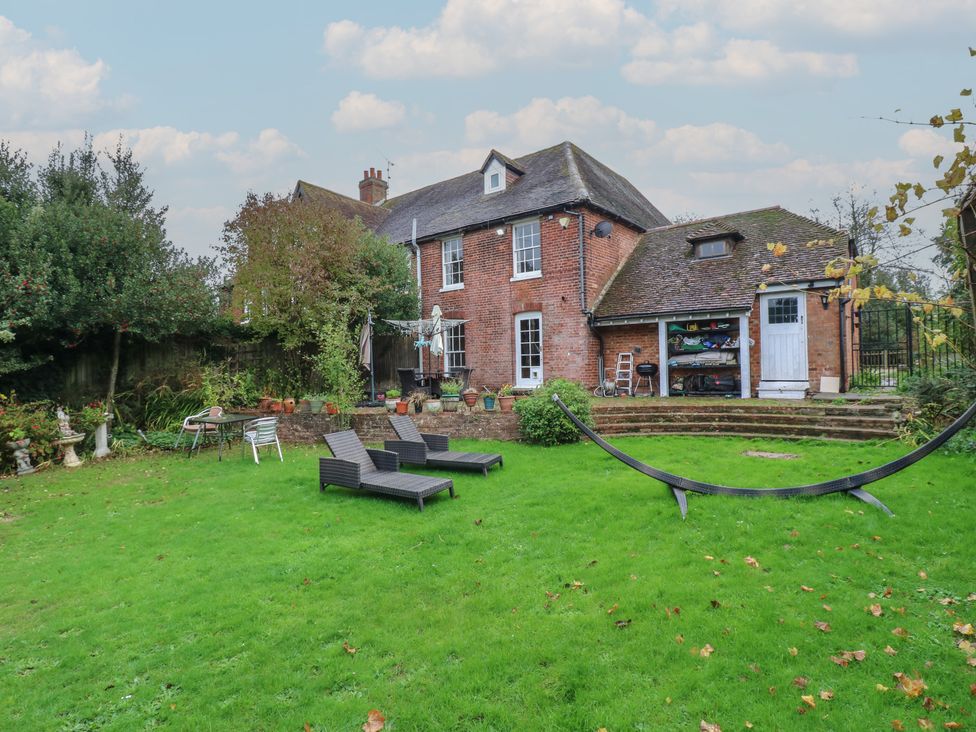 A garden with lawn chairs and a shed at Chilton Manor House in Sittingbourne