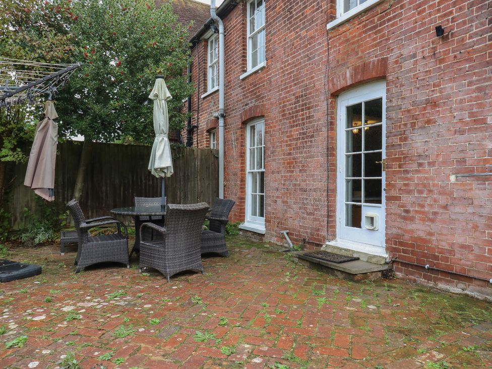 An outdoor patio area with a table and chairs at Chilton Manor House in Sittingbourne