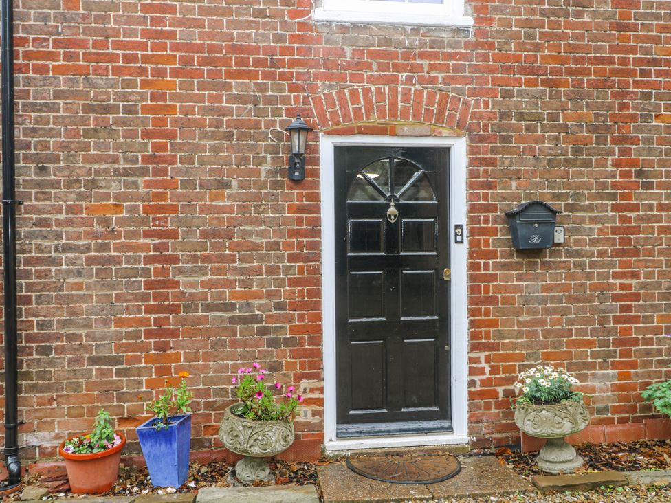 A front door with flower pots beside it at Chilton Manor House in Sittingbourne