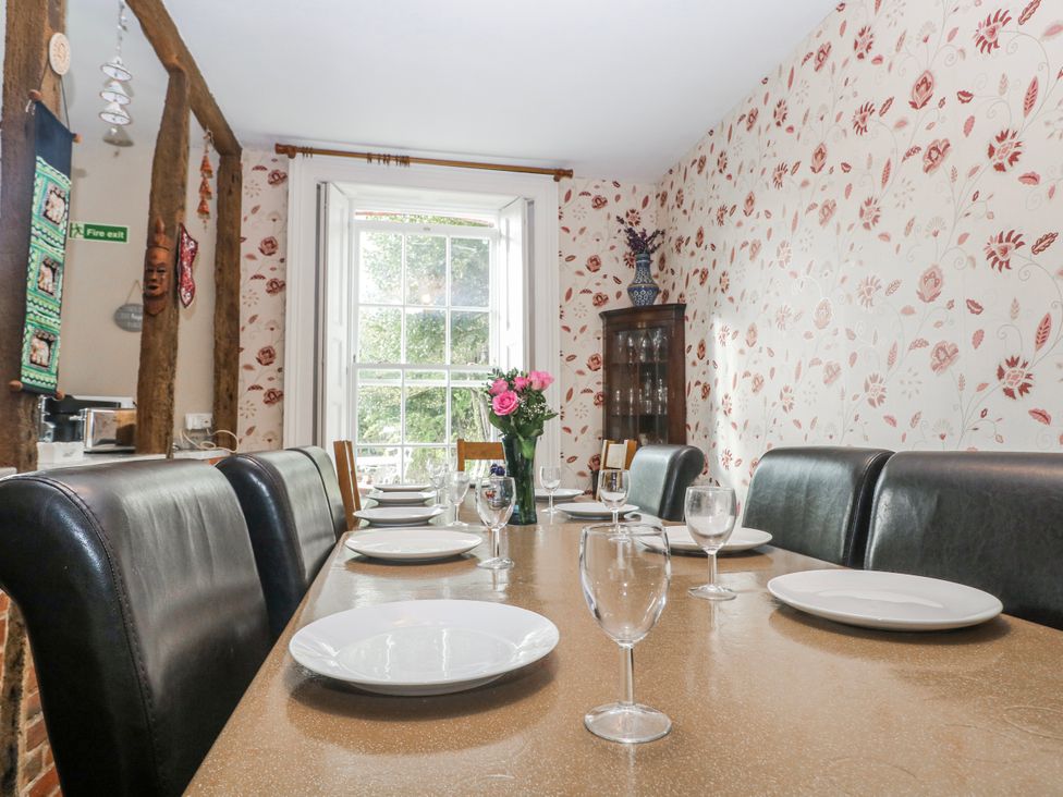 A dining room with a table set for dinner at Chilton Manor House in Sittingbourne