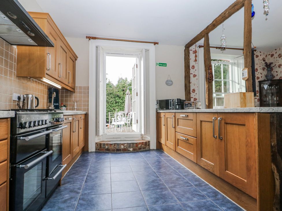 A kitchen with cabinets and appliances at Chilton Manor House in Sittingbourne