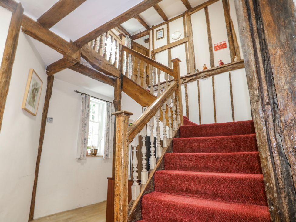 A staircase with wooden features at Chilton Manor House in Sittingbourne