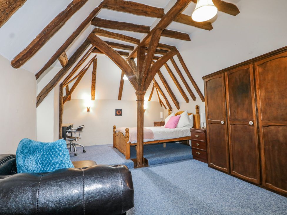 A bedroom with a bed and workspace at Chilton Manor House in Sittingbourne