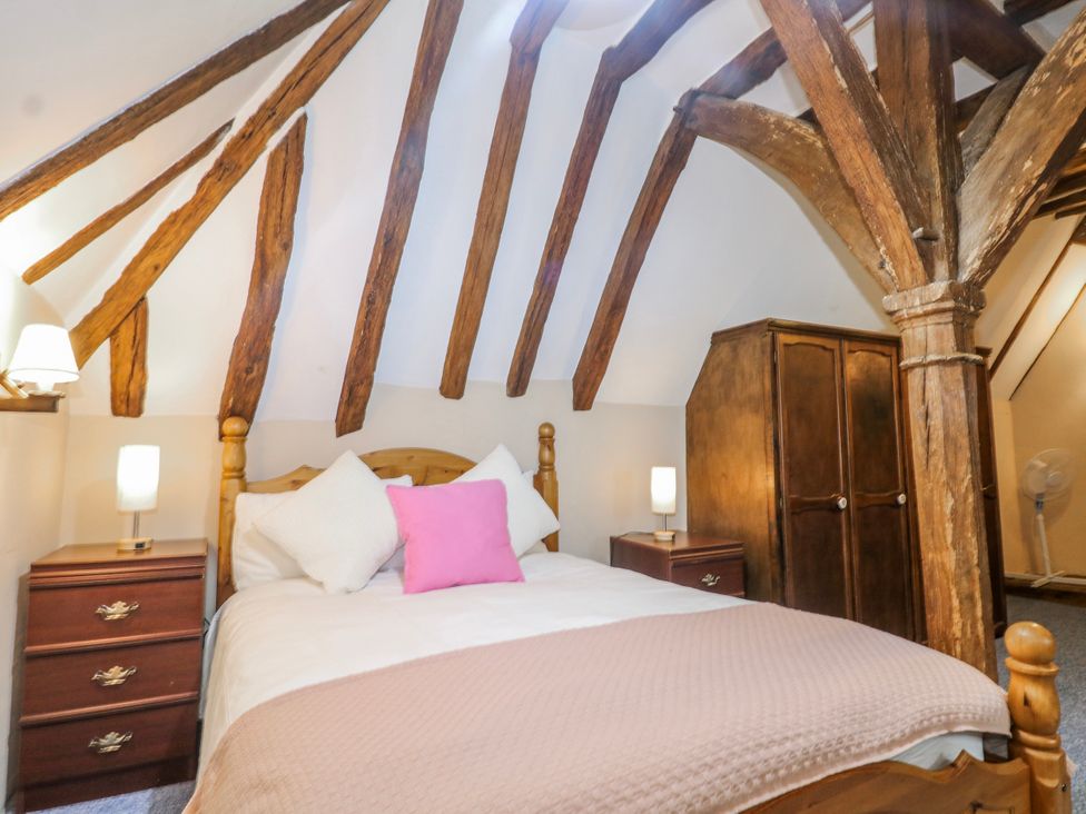 A bedroom with a bed and wardrobe at Chilton Manor House in Sittingbourne