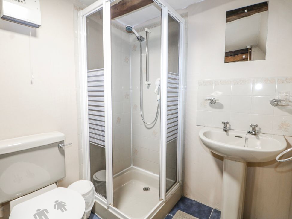 A bathroom with a shower stall, toilet, and sink at Chilton Manor House in Sittingbourne