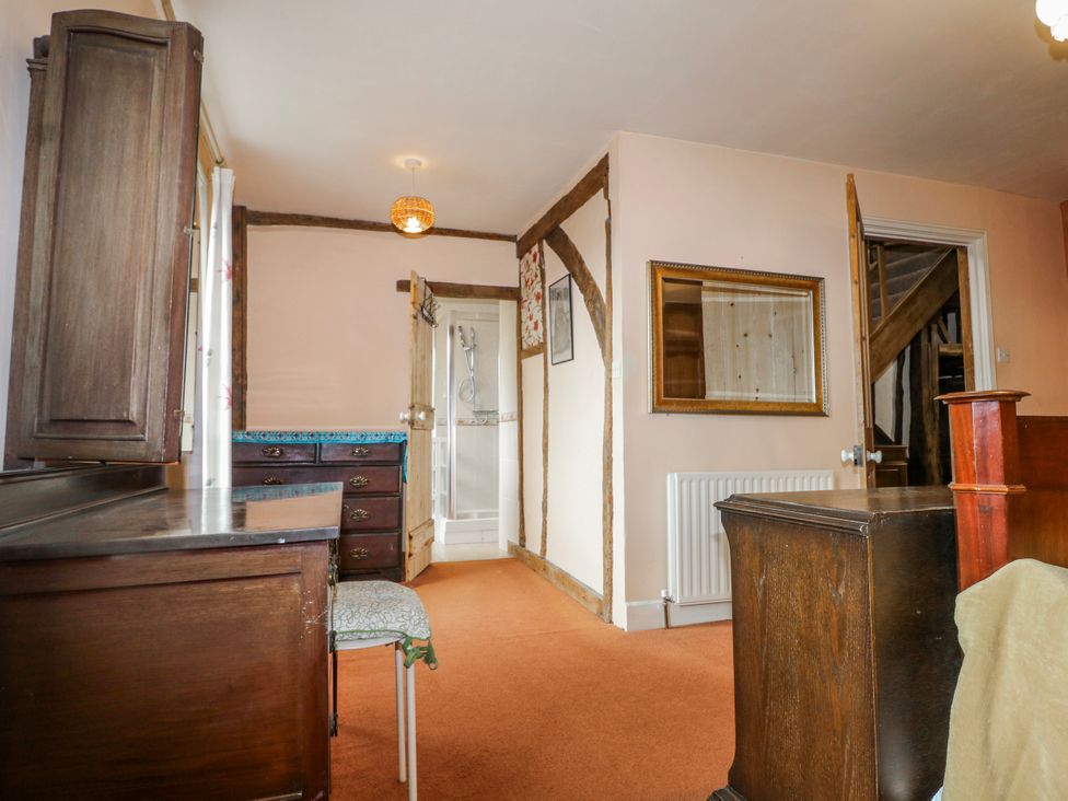 A bedroom with a desk and wardrobe at Chilton Manor House in Sittingbourne