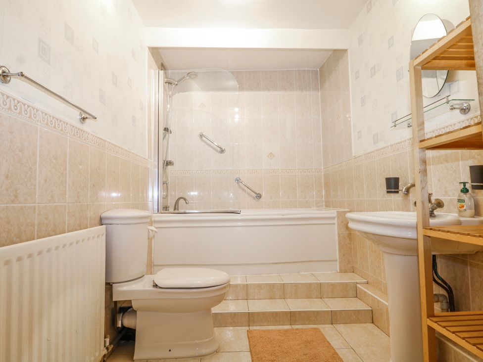 A bathroom with a bathtub, sink, and toilet at Chilton Manor House in Sittingbourne