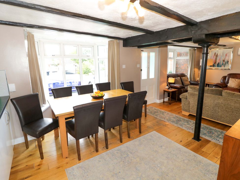 A dining room with a table and chairs at The Golden Cross Cottage Evesham