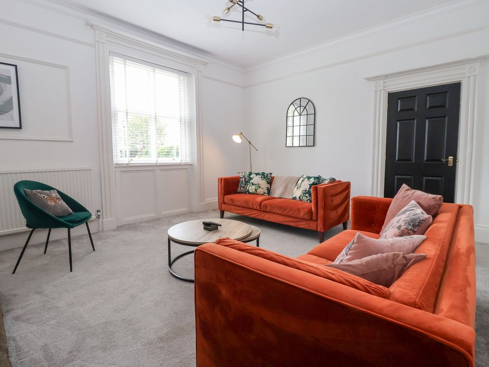 A living room with two sofas and an armchair at The Grange in Flamborough