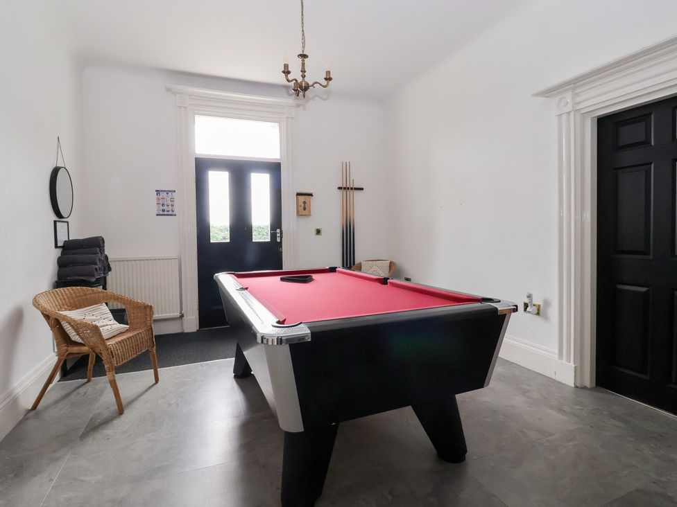 A games room with a pool table and seating at The Grange in Flamborough