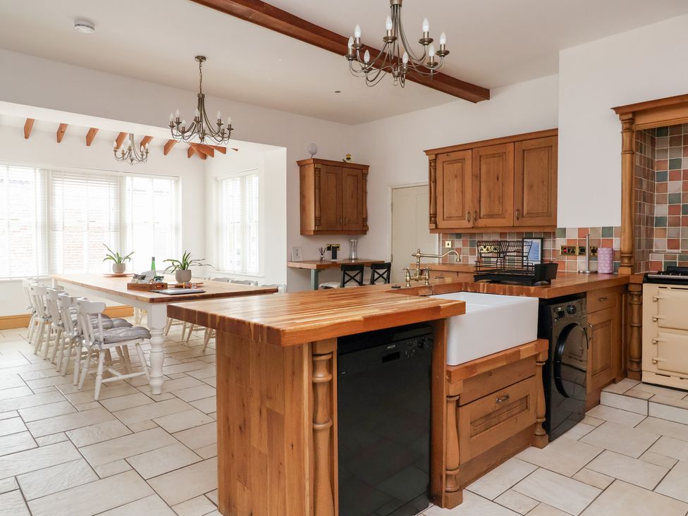 A kitchen with a wooden island and appliances at The Grange in Flamborough