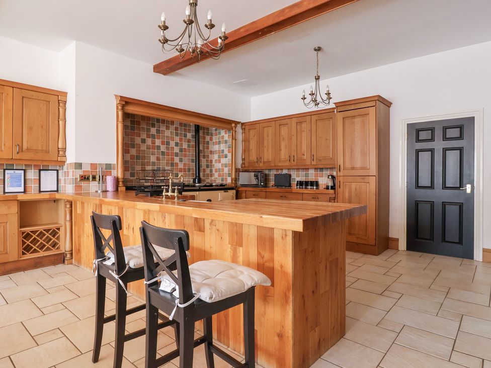 A kitchen with wooden cabinets and countertop at The Grange in Flamborough