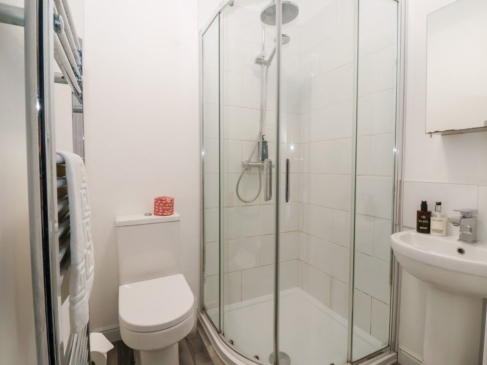 A bathroom with a shower, toilet, and sink at The Grange in Flamborough