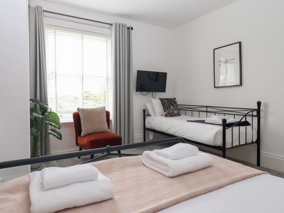 A bedroom with a double bed and a single bed at The Grange in Flamborough