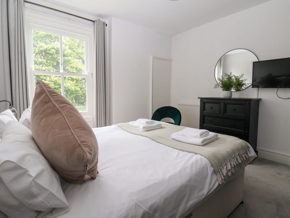 A bedroom with a bed and a dresser at The Grange in Flamborough