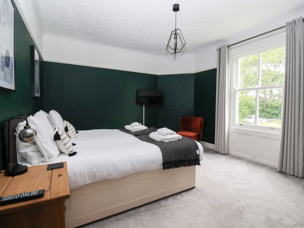 A bedroom with a bed and a chair at The Grange in Flamborough