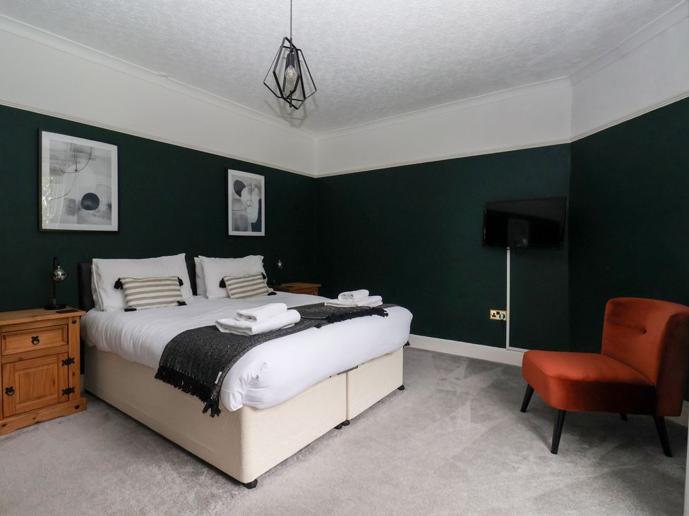 A bedroom with a bed and bedside table at The Grange in Flamborough