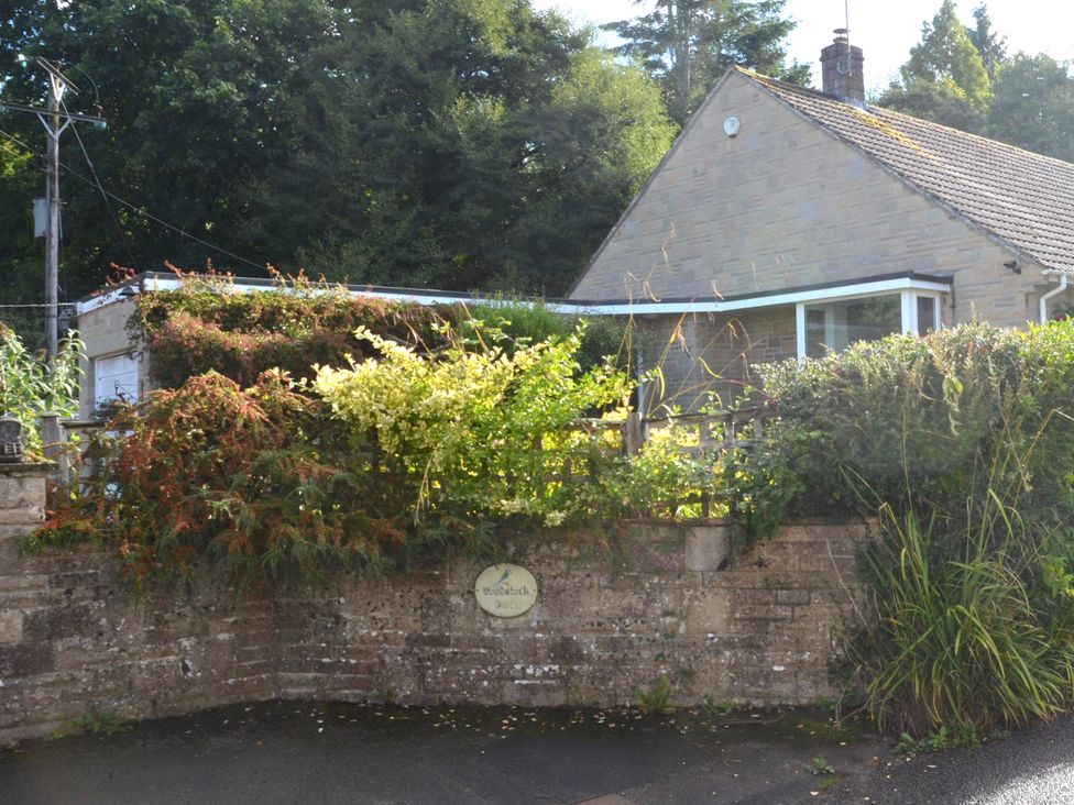 A house with a garden and a sign at Woodstock in Chard