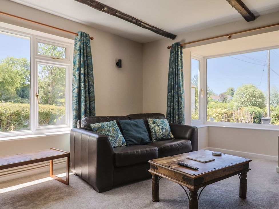 A living room with a sofa and coffee table at Woodstock in Chard