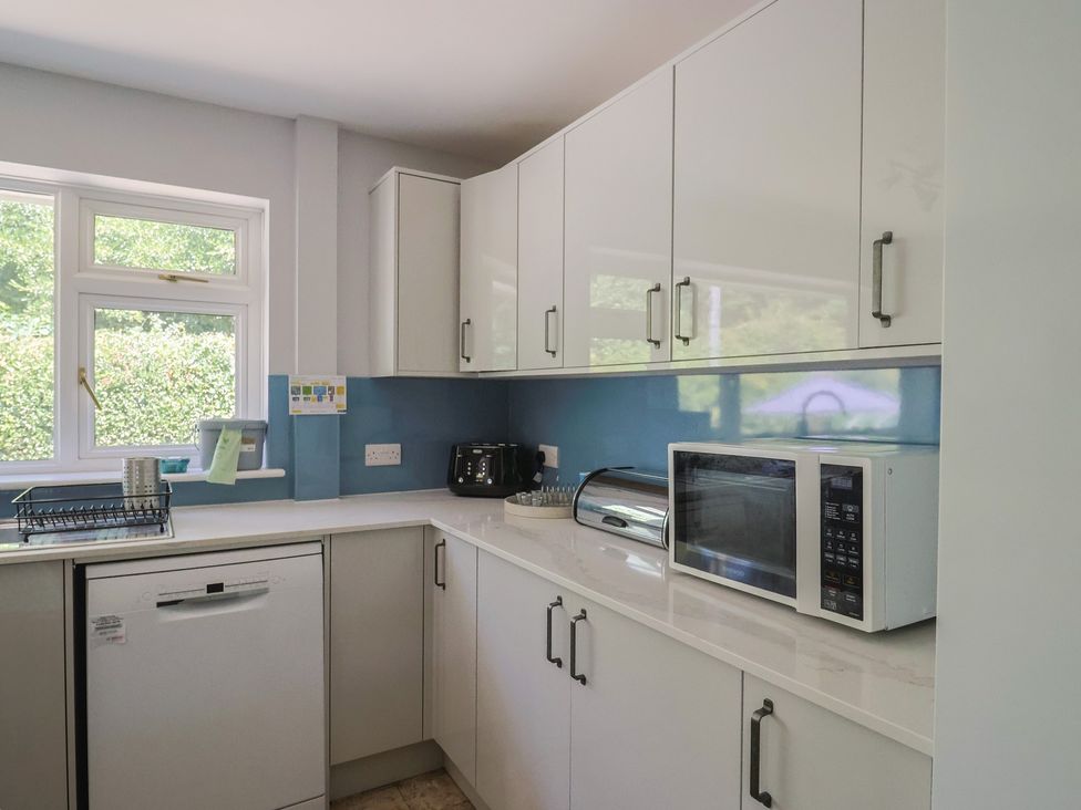 A kitchen with cabinets, sink, dishwasher, microwave and toaster at Woodstock in Chard