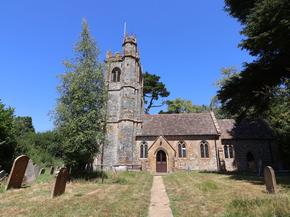 A church with a graveyard and pathway at Woodstock in Chard