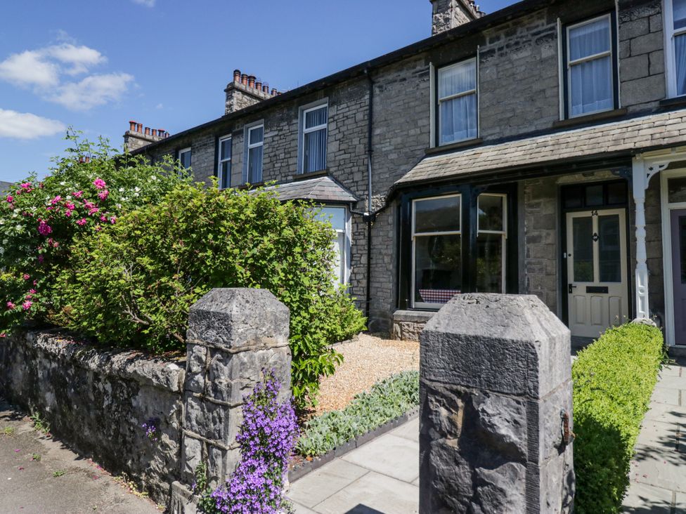 A house with a garden and rock wall at 14 Castle Garth Kendal