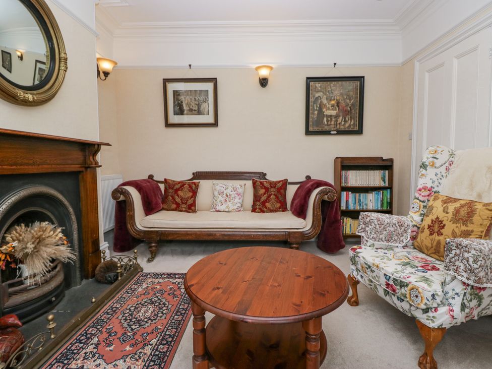 A living room with a sofa and coffee table at 14 Castle Garth in Kendal