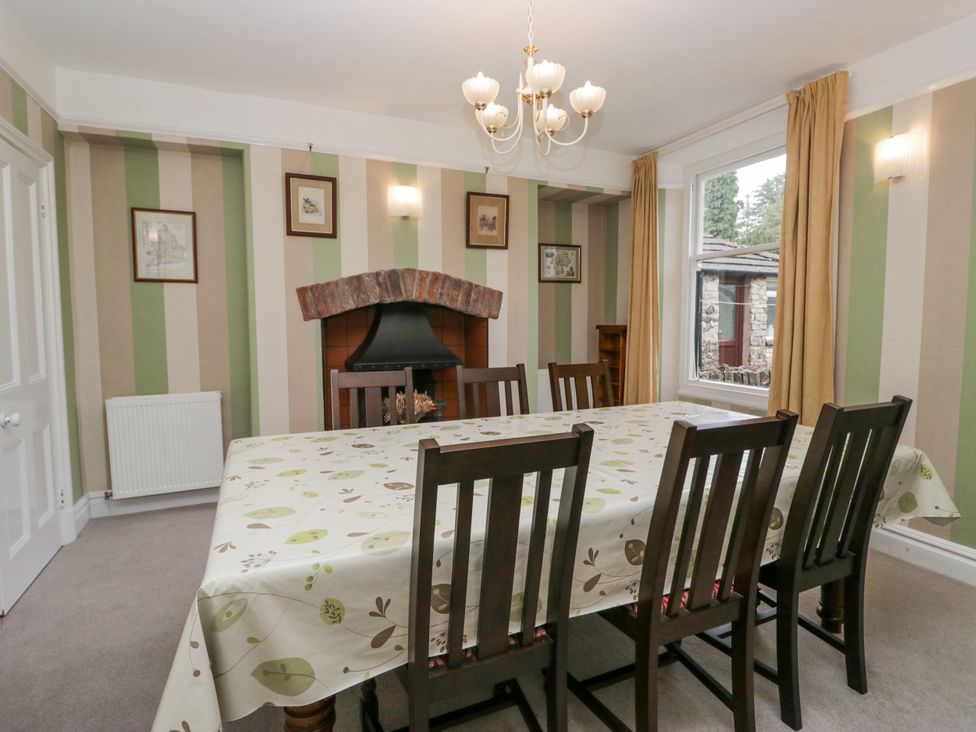 A dining room with a table and chairs at 14 Castle Garth in Kendal