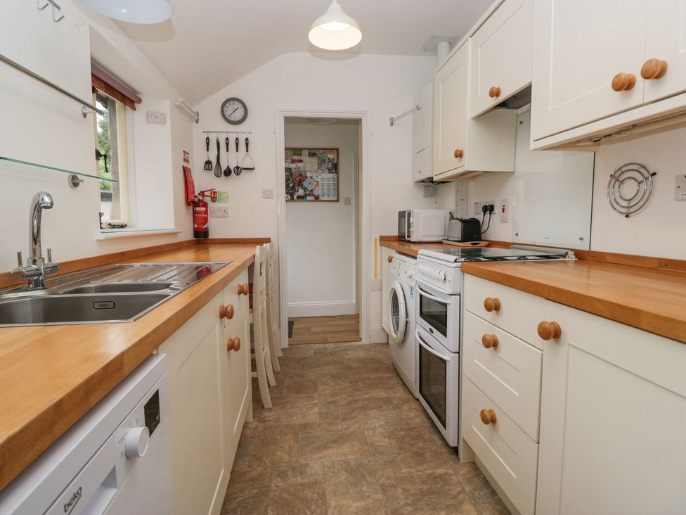 A kitchen with a sink and appliances at 14 Castle Garth in Kendal