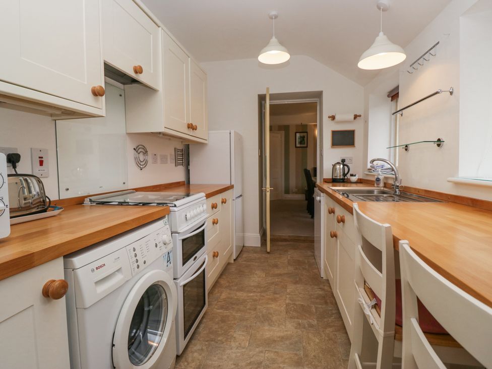 A kitchen with appliances and countertop at 14 Castle Garth Kendal