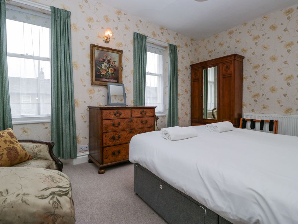 A bedroom with a bed and a chest of drawers at 14 Castle Garth Kendal