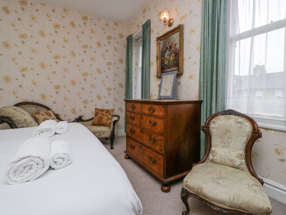 A bedroom with a bed and dresser at 14 Castle Garth Kendal