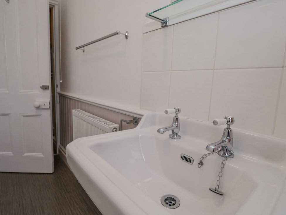 A bathroom with a sink and taps at 14 Castle Garth in Kendal