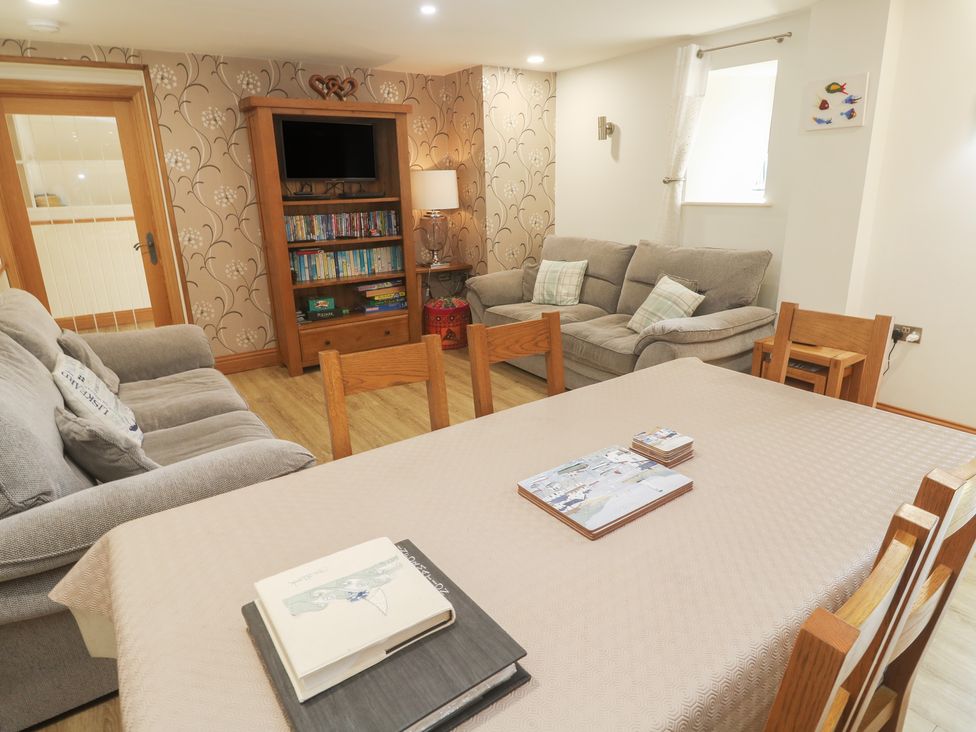 A dining room with a table and seating at Ash Barn in Falmouth
