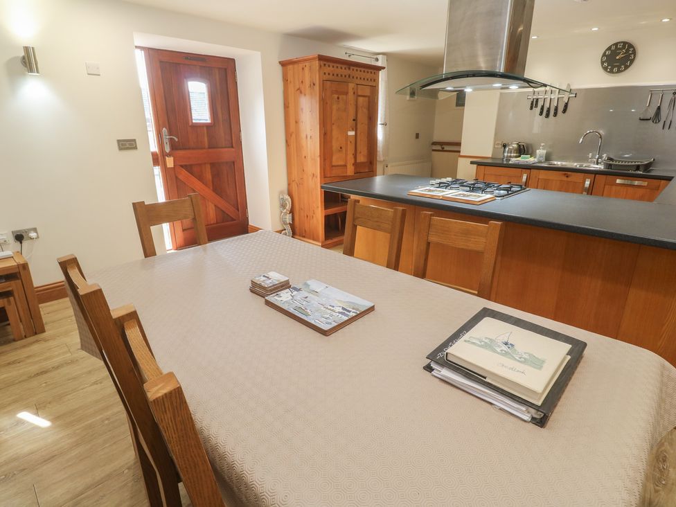 A dining room with a table and chairs at Ash Barn in Falmouth