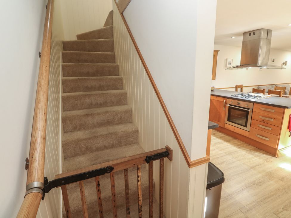 A staircase leading to a kitchen at Ash Barn in Falmouth